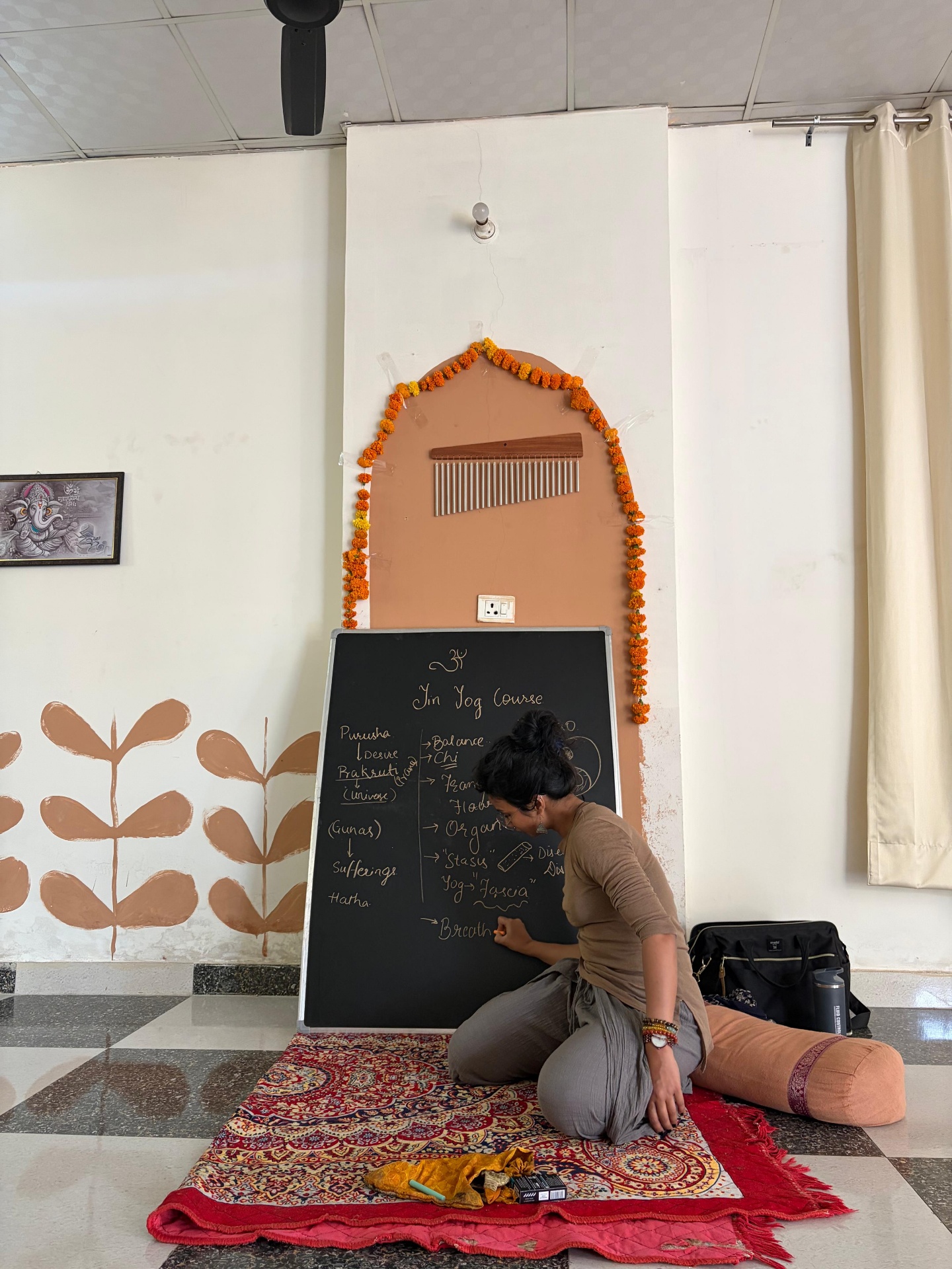 Dr. Rucha teaching at the Yin Yoga blackboard