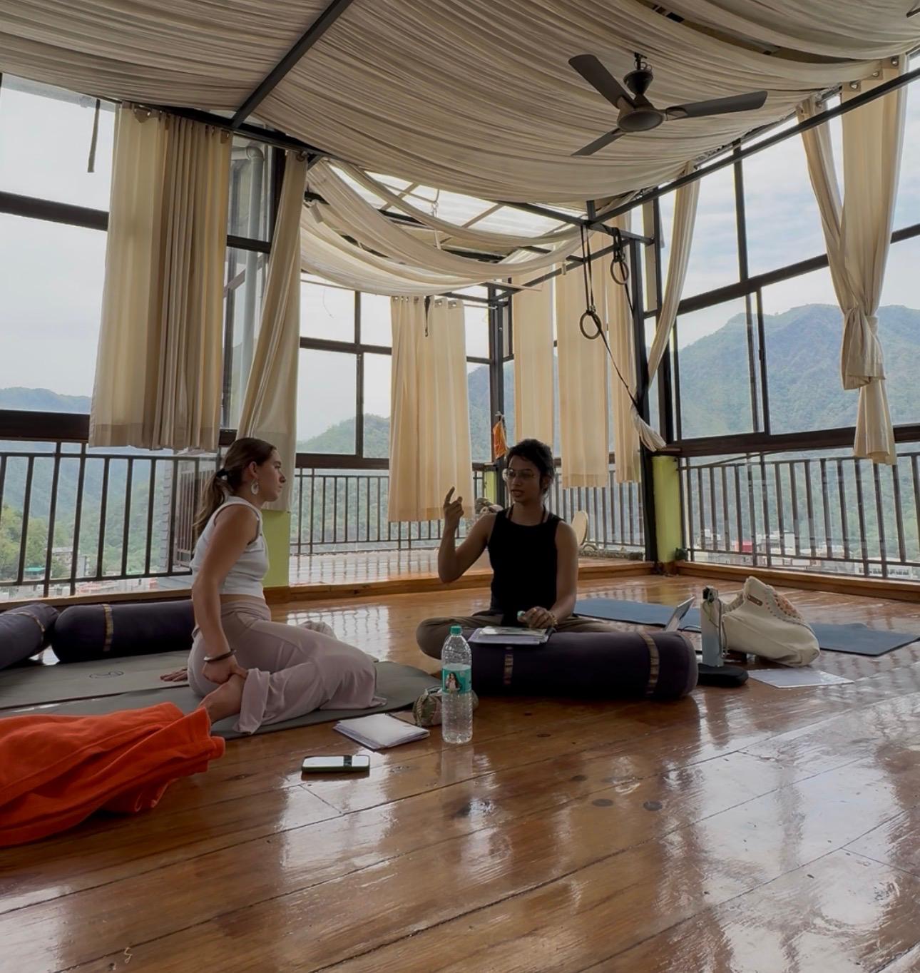 Seeker in conversation with Dr. Rucha overlooking the mountains